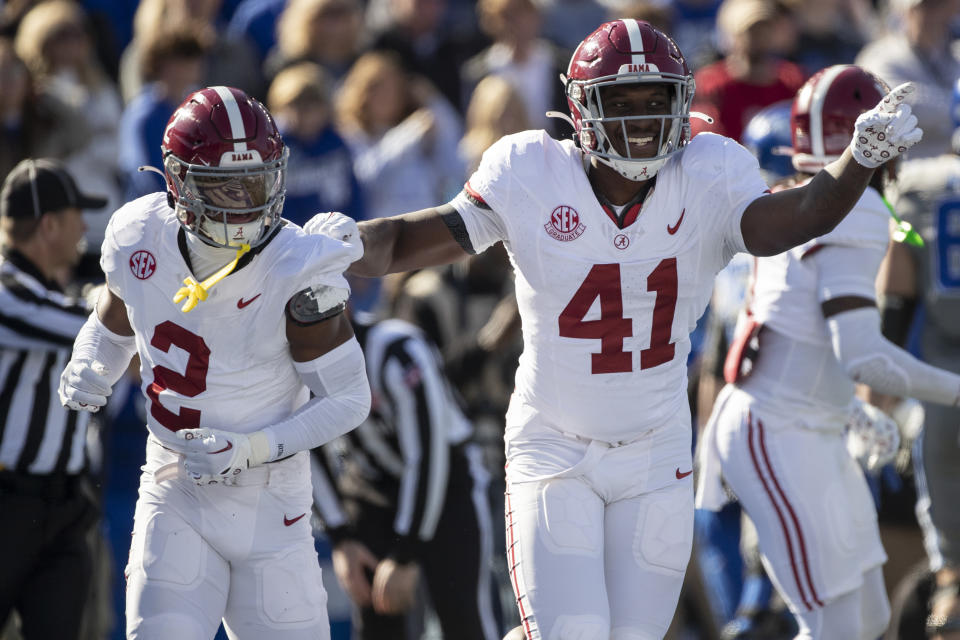 FILE - Alabama defensive back Caleb Downs (2) and linebacker Chris Braswell (41) celebrate a fumble recovery during the first half of an NCAA college football game against Kentucky in Lexington, Ky., Saturday, Nov. 11, 2023. Braswell joined fellow linebacker Dallas Turner and offensive tackle JC Latham in announcing plans to leave the Crimson Tide for the NFL He announced his decision in a post Thursday, Jan. 4, 2024, on Instagram.(AP Photo/Michelle Haas Hutchins)