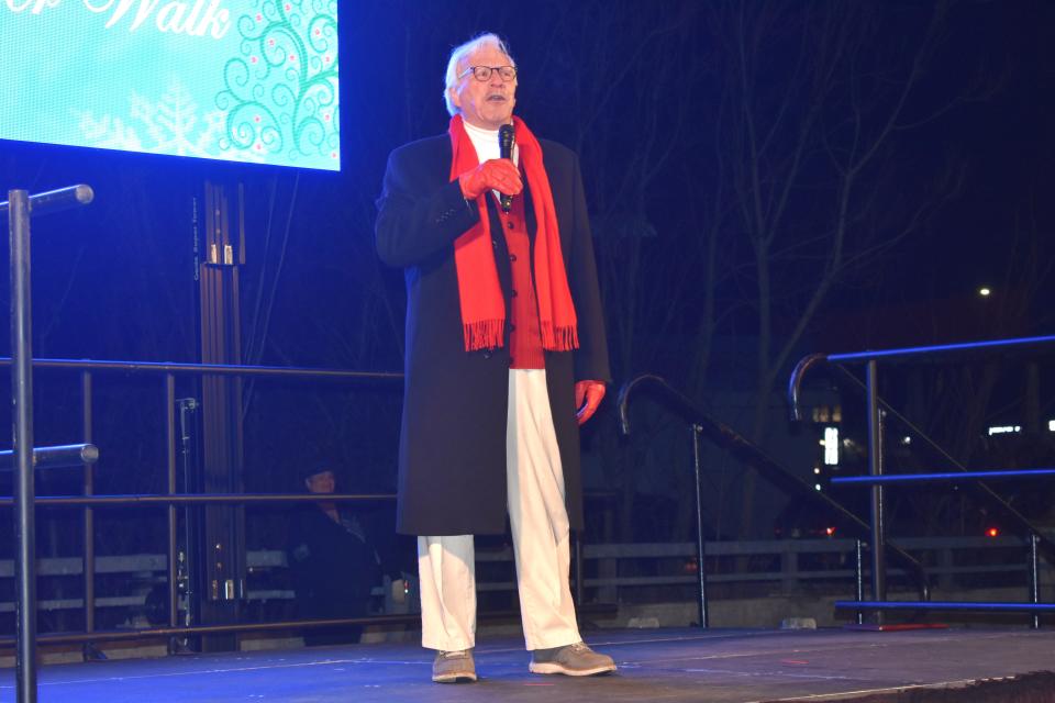 Jim Berryman, former Adrian mayor and the organizer of the Comstock Christmas Riverwalk, speaks about the lighting Friday night in downtown Adrian.