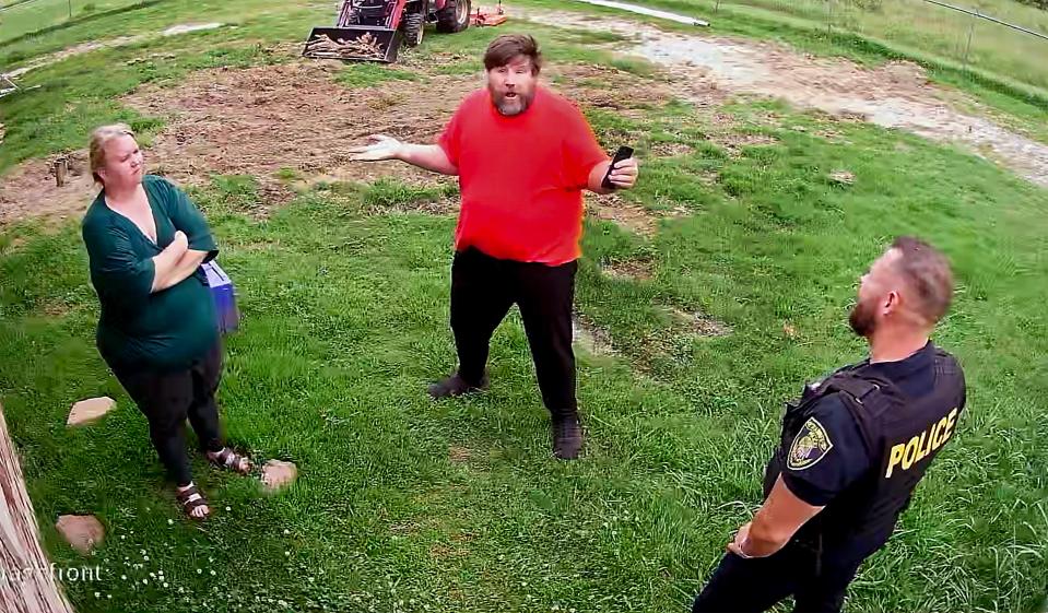 A frame grab from security video footage showing police detain a Shawnee woman before police served her husband with a municipal citation related to the couple's dog-sitting business. Photo Provided