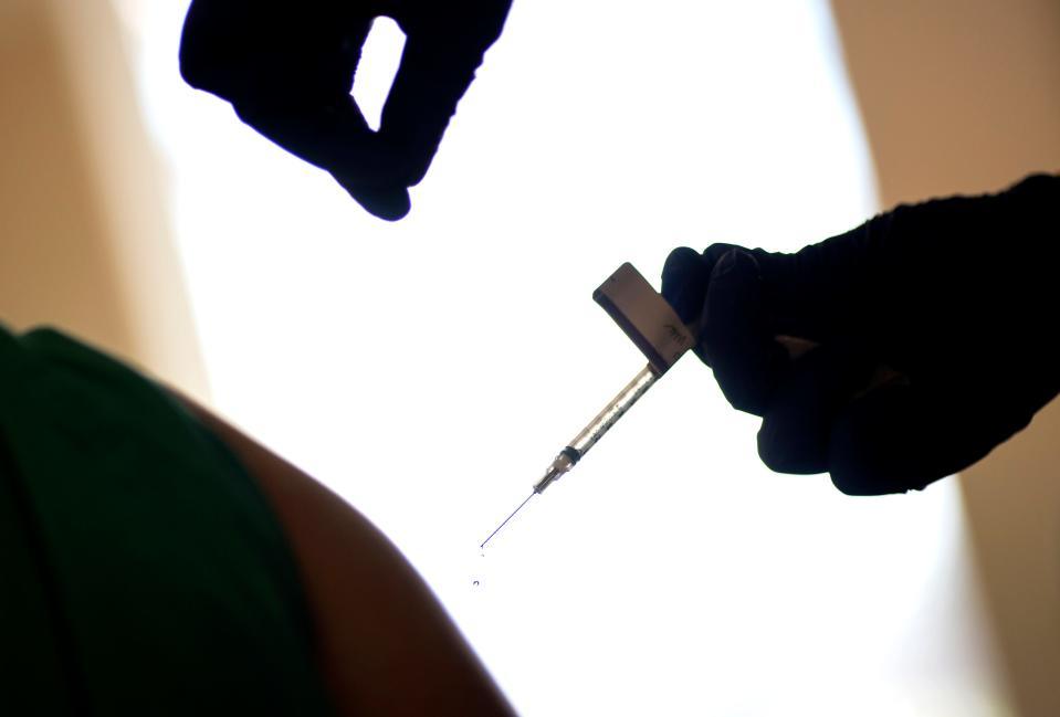 In this Dec. 15, 2020, file photo, a droplet falls from a syringe after a health care worker was injected with the Pfizer-BioNTech COVID-19 vaccine at Women & Infants Hospital in Providence, R.I.