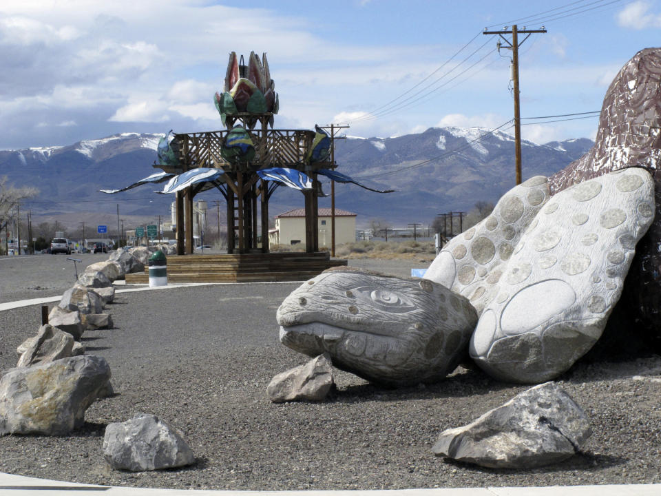 This photo taken Thursday, March 18, 2021 in Fernley, Nev. shows sculptures of a desert tortoise and a flower made out of bottle caps. The town was founded about 30 miles east of Reno a century ago after the first major irrigation project in the West was built to "make the desert bloom." The city is suing the U.S. government over plans to renovate an earthen irrigation canal that burst and flooded nearly 600 homes in Fernley in 2008. (AP Photo/Scott Sonner)