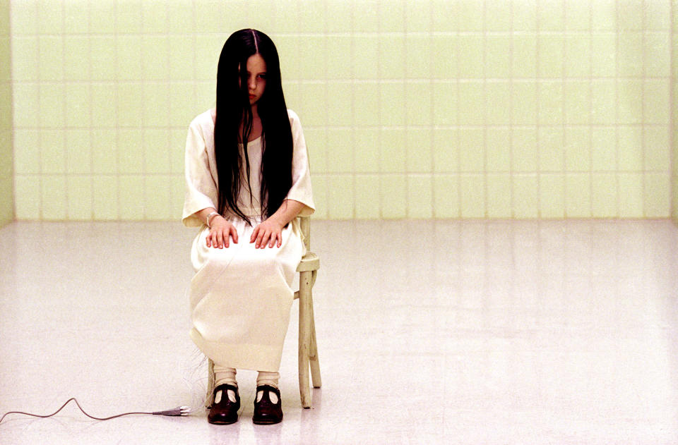 Daveigh Chase sitting in a chair.