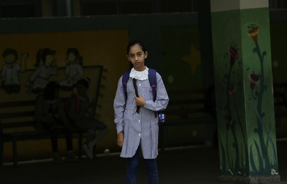 A student walks to class on the first day of the new school year at the United-Nation run Elementary School at the Shati refugee camp in Gaza City, Saturday, Aug. 8, 2020. Schools run by both Palestinian government and the U.N. Refugee and Works Agency (UNRWA) have opened almost normally in the Gaza Strip after five months in which no cases of community transmission of the coronavirus had been recorded. (AP Photo/Adel Hana)