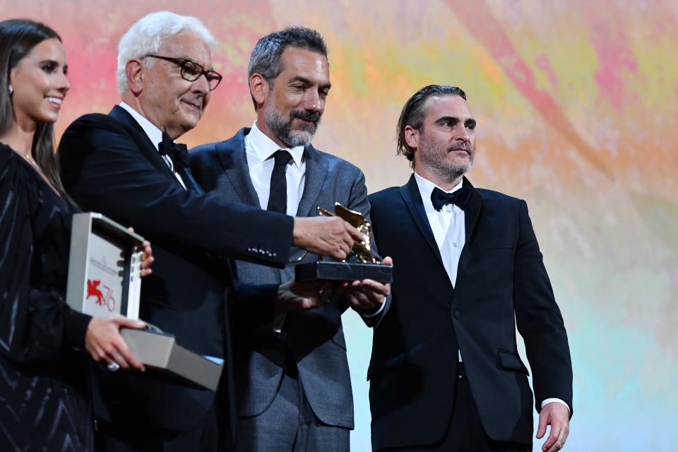 US director Todd Phillips (C), flanked by US actor Joaquin Phoenix (R) and President of the Venice Biennale Paolo Baratta, holds the Golden Lion award for Best Film he received for the movie "Joker" during the awards ceremony of the 76th Venice Film Festival on September 7, 2019 at Venice Lido. (Photo by Alberto PIZZOLI / AFP)        (Photo credit should read ALBERTO PIZZOLI/AFP/Getty Images)