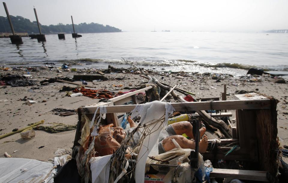 A toy doll is seen on Fundao beach in the Guanabara Bay in Rio de Janeiro