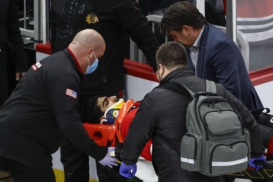 Chicago Blackhawks center Jujhar Khaira (16) leaves the ice on a stretcher after he was knocked out by New York Rangers defenseman Jacob Trouba during the second period of an NHL hockey game, Tuesday, Dec. 7, 2021, in Chicago. (AP Photo/Kamil Krzaczynski)