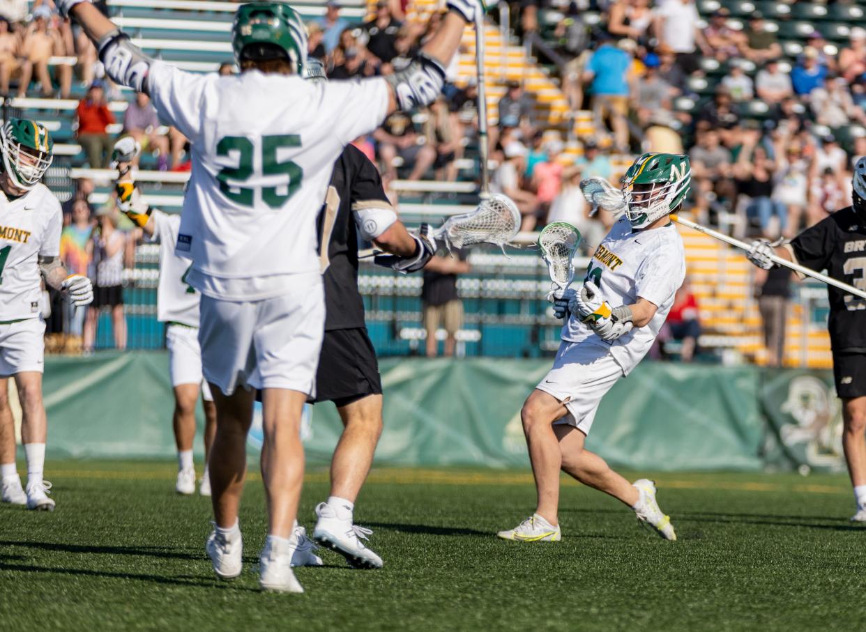 The University of Vermont men's lacrosse team celebrate during a 13-12 win against Bryant on April 15, 2023 at Virtue Field.