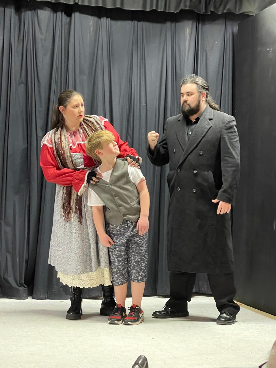 Adrianna LeDonne, left, as Nancy, Eli Gowan, as Oliver, and Alexander Bonner, as Bill Sikes, rehearse a scene for Footlight Players' production of "Oliver!" that opens March 3 and continues through March 19, 2023, at the theater in Michigan City.