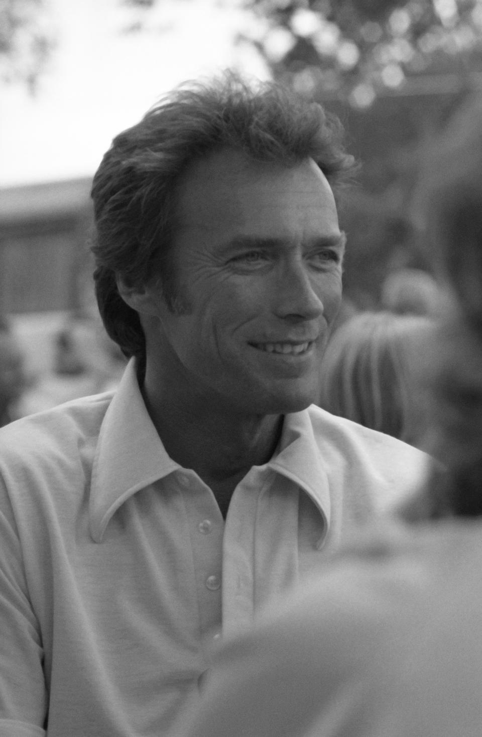 Smiling man in casual shirt at an outdoor event