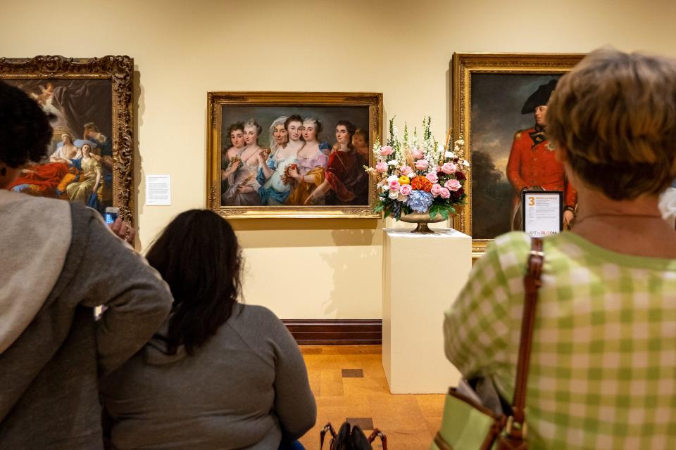 Visitors to the David Owsley Museum of Art on the Ball State University campus take in the 2023 "Art in Bloom" exhibition.