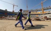 FILE PHOTO: Workers are seen inside the Lusail stadium which is under construction for the upcoming 2022 Fifa soccer World Cup during a stadium tour in Doha