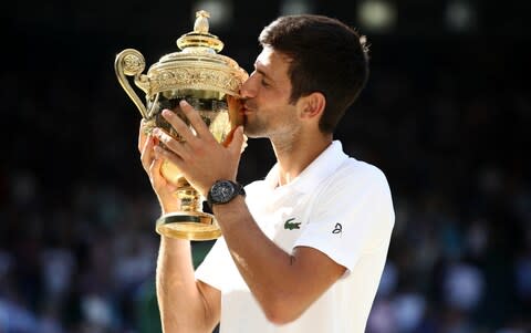 Djokovic with Wimbledon trophy - Credit: PA