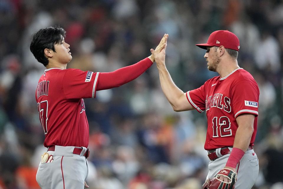 Los Angeles Angels' Shohei Ohtani (17) and Hunter Renfroe (12) celebrate after a baseball game against the Houston Astros Sunday, June 4, 2023, in Houston. The Angels won 2-1. (AP Photo/David J. Phillip)