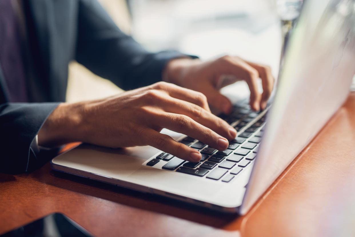 Man typing on laptop