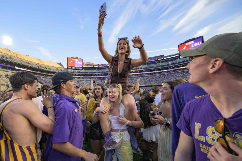 Fans celebrate after they came onto the field after LSU defeated Mississippi in an NCAA college football game in Baton Rouge, La., Saturday, Oct. 22, 2022. (AP Photo/Matthew Hinton)