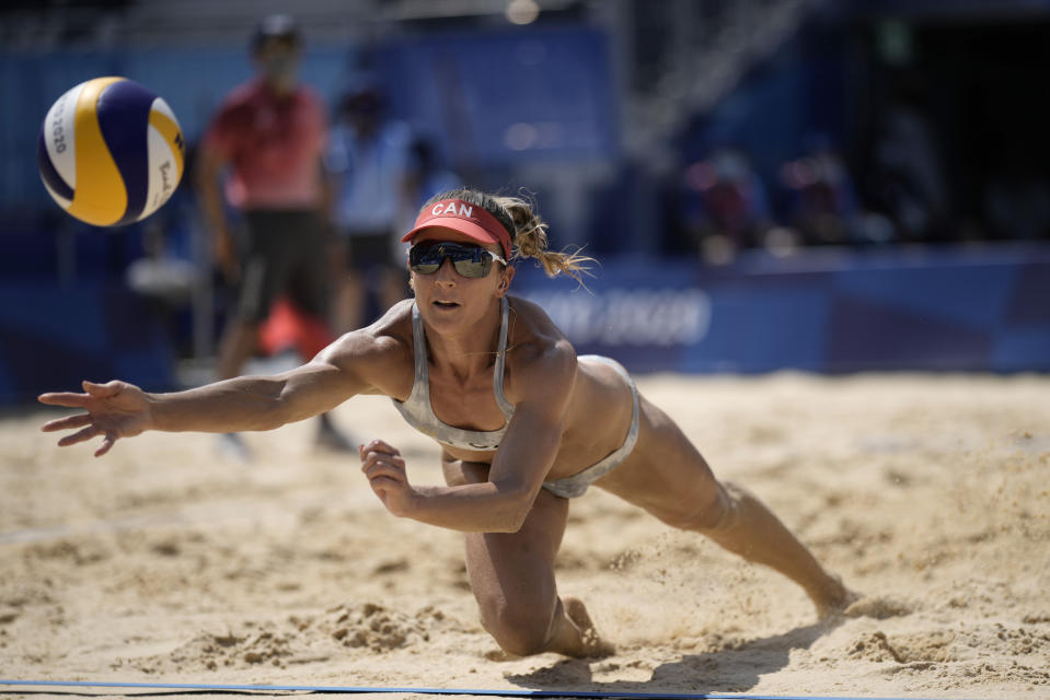 Heather Bansley, of Canada, dives for the ball during a women's beach volleyball match against the United States at the 2020 Summer Olympics, Sunday, Aug. 1, 2021, in Tokyo, Japan. (AP Photo/Felipe Dana)