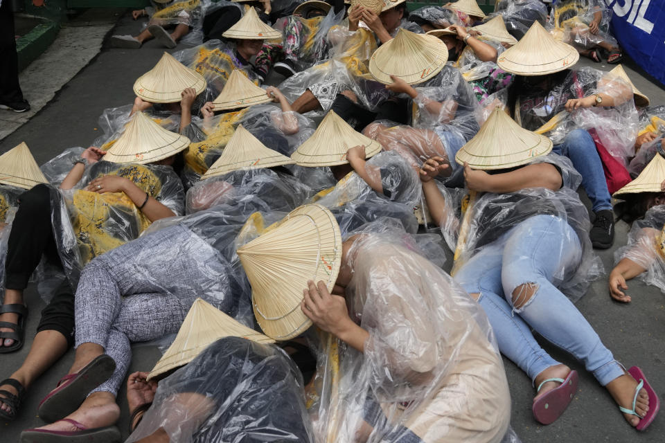 Protesters lie in front of the Department of Environment and Natural Resources as part of their program during their global march to end fossil fuel on Friday, Sept. 15, 2023, in Quezon city, Philippines. Tens of thousands of climate activists around the world are set to march, chant and protest Friday to call for an end to the burning of planet-warming fossil fuels as the globe continues to suffer dramatic weather extremes and topple heat records. (AP Photo/Aaron Favila)