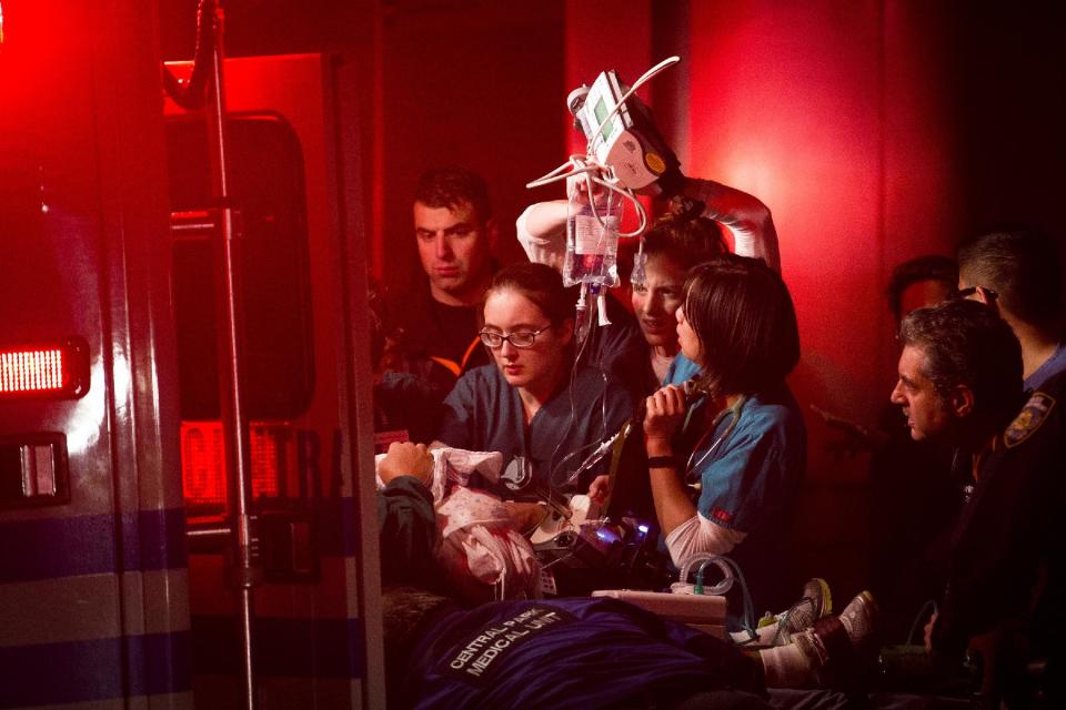 Medical workers assist a patient into an ambulance during an evacuation of New York University's Tisch Hospital, Monday, Oct. 29, 2012, in New York. The New York City hospital is moving out more than 200 patients after its backup generator failed when the power was knocked out by a superstorm. (AP Photo/ John Minchillo)