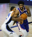 Philadelphia 76ers' Joel Embiid, right, drives the ball against Orlando Magic's Khem Birch during the second half of an NBA basketball game Friday, Aug. 7, 2020, in Lake Buena Vista, Fla. (Kevin C. Cox/Pool Photo via AP)