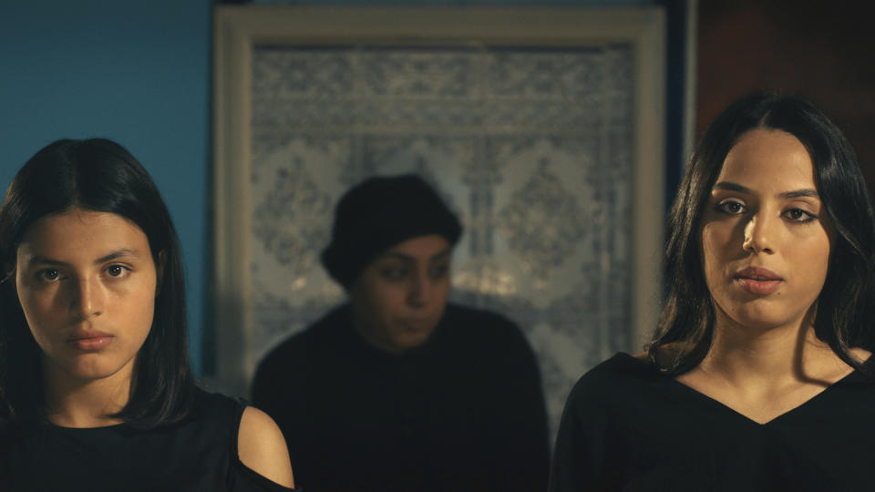 This image provided by Kino Lorber shows Tayssir Chikhaoui, Olfa Hamrouni, center, Eya Chikhaoui in the movie Four Daughters, filmed in Tunis, Tunisia. The film about a Tunisian family and the radicalization of two teenage daughters who joined the Islamic State is up for one of the most prestigious film awards in the world. (Kino Lorber via AP)