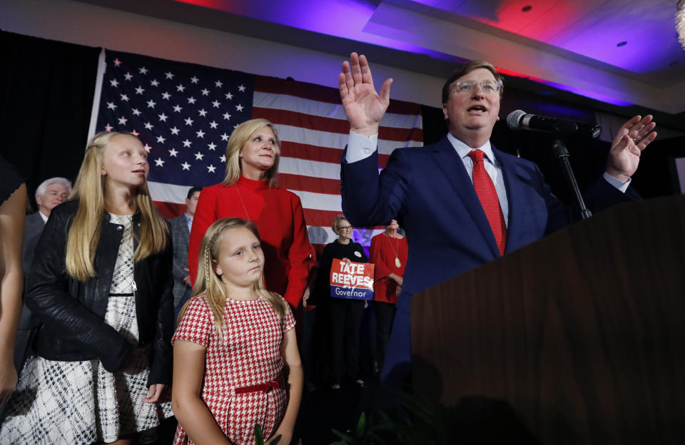 Republican Gov.-elect Tate Reeves addresses his supporters at a state GOP election night victory party, as wife, Elee Reeves, rear, and daughters Elizabeth, left, and Madeline, foreground, listen, Tuesday, Nov. 5, 2019, in Jackson, Miss. Reeves defeated Democratic Attorney General Jim Hood. (AP Photo/Rogelio V. Solis)