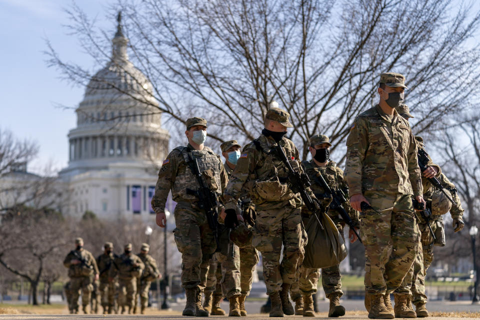 Members of the National Guard patrol outside the Capitol Building on Capitol Hill in Washington, Thursday, Jan. 14, 2021. (AP Photo/Andrew Harnik)