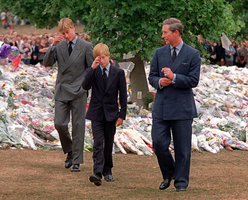 FILE - In this Friday, Sept. 5, 1997 file photo Britain's Prince Charles, right, accompanies his sons Prince William, left and Prince Harry after they arrived at Kensington Palace to view tributes left in memory of their mother Princess Diana in London. Prince Charles is sandwiched between generations, caught between his mother, a symbol of dignity and continuity who has reigned since 1952, and his two immensely popular sons, Prince William and Prince Harry, who have along with their wives come to symbolize the future of the world’s best known monarchy. (AP Photo/David Brauchli, File)