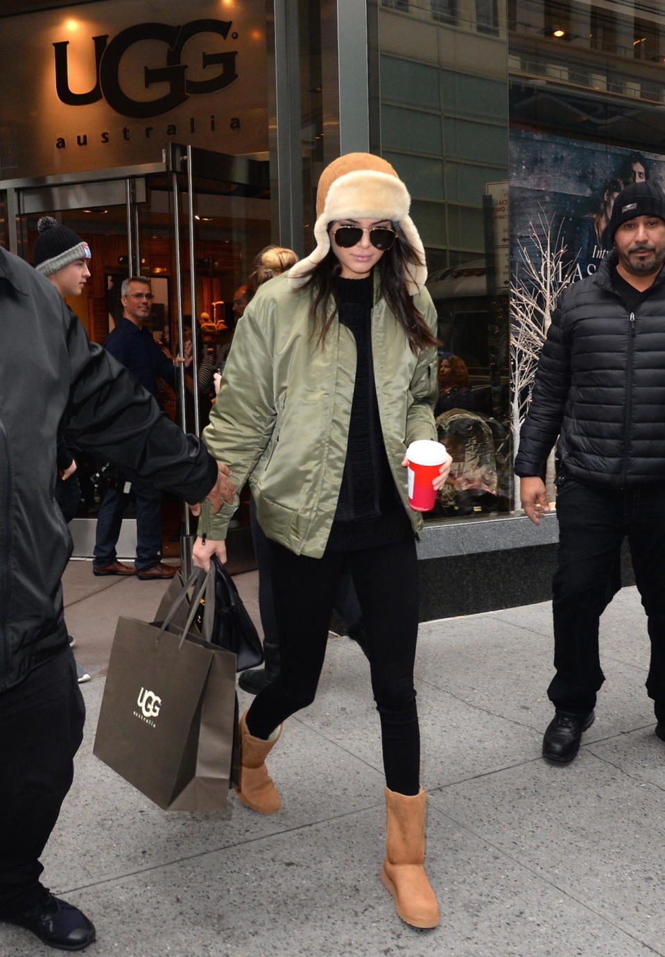 <p>The day after filming her first Victoria’s Secret Fashion Show, Jenner looked comfy-cozy for a shopping stop at the Ugg store with younger sister Kylie. The model wore a satiny, moss-green bomber jacket over an all-black outfit, as well as a suede trapper hat and Ugg boots that she seems to have purchased then and there. Could Jenner be the one to make Uggs cool again in the fashion crowd? </p>