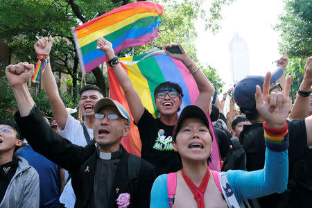 Same-sex marriage supporters celebrate after Taiwan became the first place in Asia to legalize same-sex marriage, outside the Legislative Yuan in Taipei, Taiwan May 17, 2019. REUTERS/Tyrone Siu