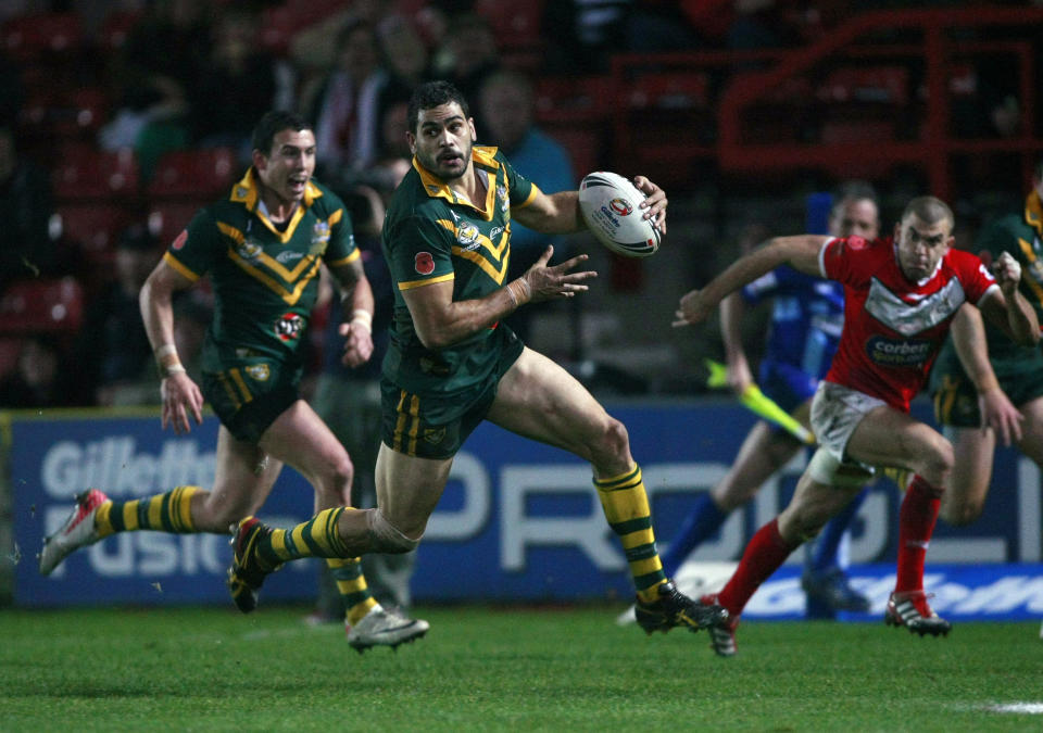 FILE- Australia's Greg Inglis, second left, makes a break against Wales during their four nations rugby league test match at the Racecourse Ground, Wrexham, Wales, Nov. 13, 2011. Australia’s National Rugby League is hoping that the old adage of what happens in Vegas, stays in Vegas, will hold true for its proposed first major push into the U.S. sports market.(AP Photo/Tim Hales, File)