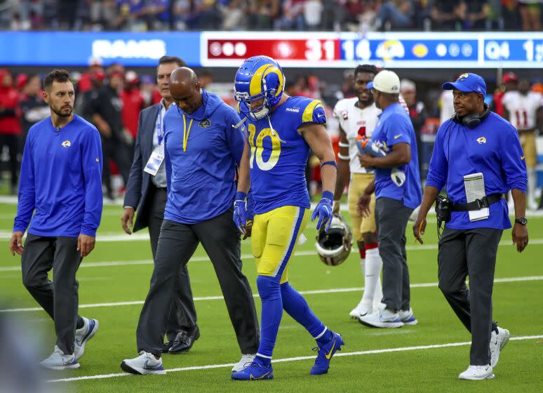 Inglewood, CA - October 30: Rams wide receiver Cooper Kupp walks off the field with medical staff after getting injured and apparently avoided a major injury at the end of Sunday's loss to the 49ers. Kupp is expected to play against the Buccaneers this week. The 49ers beat the Rams 31-14 at SoFi Stadium in Inglewood Sunday, Oct. 30, 2022. (Allen J. Schaben / Los Angeles Times)