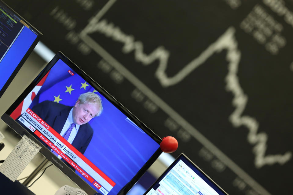 A television broadcast showing Britain's Prime Minister Boris Johnson during a news conference with European Commission President Jean-Claude Juncker after agreeing on the Brexit deal is pictured at Frankfurt's stock exchange in Frankfurt, Germany, October 17, 2019. REUTERS/Ralph Orlowski