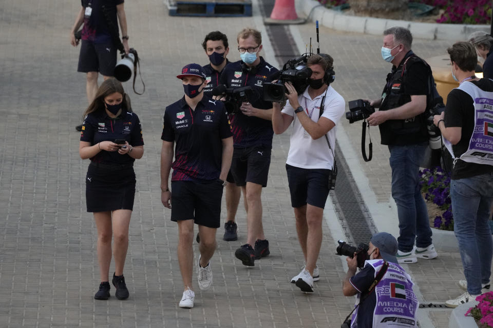 Red Bull driver Max Verstappen of the Netherlands arrives for his press conference with Mercedes driver Lewis Hamilton of Britain at the Yas Marina racetrack in Abu Dhabi, United Arab Emirates, Thursday, Dec. 9, 2021. (AP Photo/Hassan Ammar)