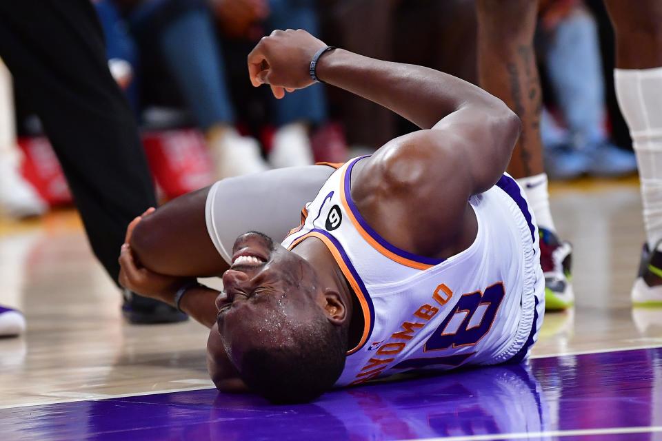 Apr 7, 2023; Los Angeles, California, USA; Phoenix Suns center Bismack Biyombo (18) reacts after suffering an apparent injury against the Los Angeles Lakers during the first half at Crypto.com Arena. Mandatory Credit: Gary A. Vasquez-USA TODAY Sports