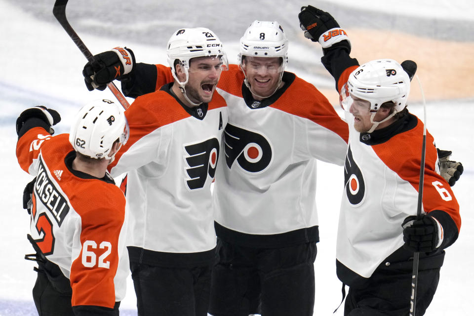 Philadelphia Flyers' Scott Laughton (21) celebrates with Olle Lycksell (62), Cam York (8) and Travis Sanheim (6) after scoring during the first period of an NHL hockey game against the Pittsburgh Penguins in Pittsburgh, Sunday, Feb. 25, 2024. (AP Photo/Gene J. Puskar)