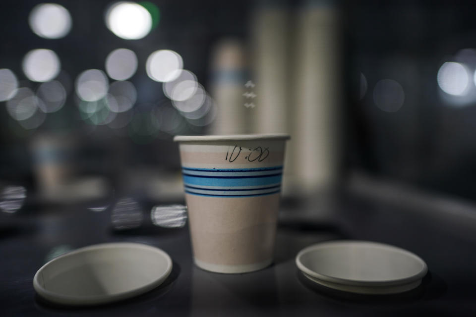 A small paper cup sits in a storage area as it's used in the manfacturing of solar panels inside the Hanwha Qcells Solar plant, Monday, Oct. 16, 2023, in Dalton, Ga. (AP Photo/Mike Stewart)