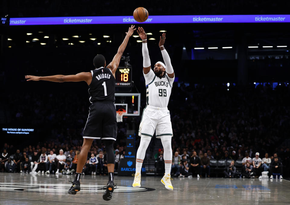 Milwaukee Bucks forward Jae Crowder (99) shoots over Brooklyn Nets forward Mikal Bridges (1) during the second half of an NBA basketball game, Monday, Nov. 6, 2023, in New York. (AP Photo/Noah K. Murray)