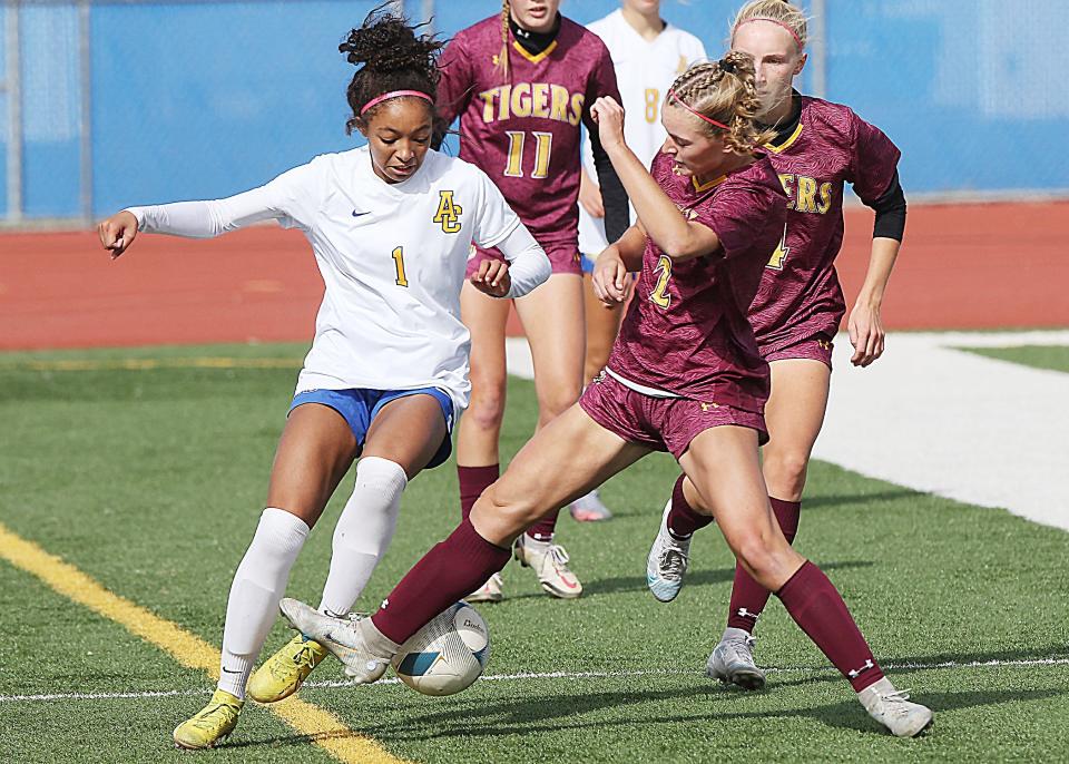 Aberdeen Central's Deshani Peters (left) battles for the ball with a Harrisburg player during the 2022 state Class AA girls soccer championship.