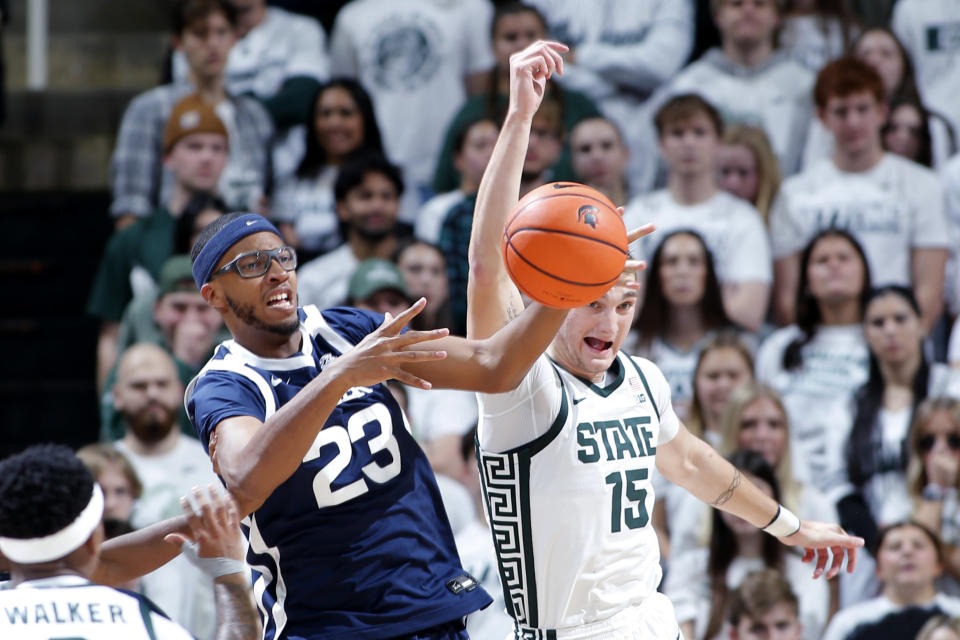 Butler's Andre Screen, left, and Michigan State's Carson Cooper (15) vie for a rebound during the first half of an NCAA college basketball game Friday, Nov. 17, 2023, in East Lansing, Mich. (AP Photo/Al Goldis)