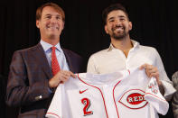 Cincinnati Reds' Nick Castellanos, right, holds his jersey alongside Reds president and director of operations Dick Williams during a news conference, Tuesday, Jan. 28, 2020, in Cincinnati. Castellanos signed a $64 million, four-year deal with the baseball club. (AP Photo/John Minchillo)