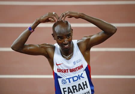 Mo Farah of Britain gestures after winning the men's 5000 metres final at the 15th IAAF Championships at the National Stadium in Beijing, China August 29, 2015. REUTERS/David Gray