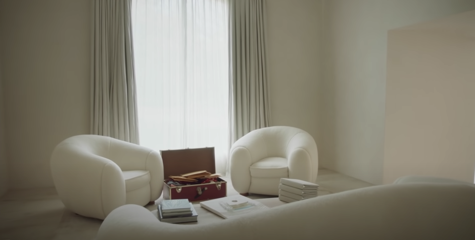 cream colored chairs facing a matching sofa and coffee table