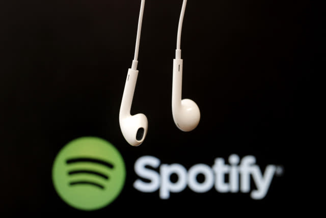 Headphones are seen in front of a logo of online music streaming service Spotify in this illustration picture taken in Strasbourg, February 18, 2014. Spotify is recruiting a U.S. financial reporting specialist, adding to speculation that the Swedish start-up is preparing for a share listing, which one banker said could value the firm at as much as $8 billion. REUTERS/Christian Hartmann (FRANCE - Tags: BUSINESS ENTERTAINMENT LOGO) - GM1EA2I1FZ401