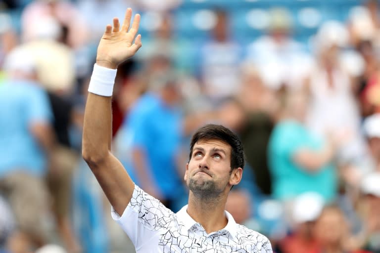 Things are looking up: Novak Djokovic celebrates his win over Grigor Dimitrov