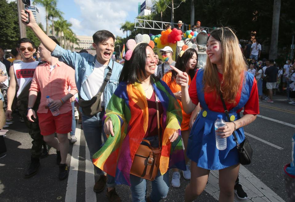 Participants march through the street during an LGBTQ pride parade in Taipei, Taiwan, Oct. 31, 2020. In the U.S., most pride events in June were canceled.