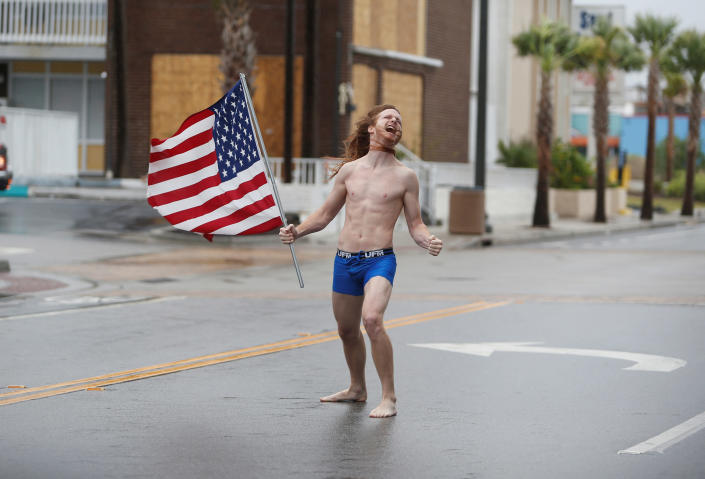 <p>Lane Pittman of Jacksonville, Florida, stands in the wind and rain along Ocean Boulevard during Hurricane Florence in Myrtle Beach, S.C., on Friday, Sept. 14, 2018. (Photo: Randall Hill/Reuters) </p>