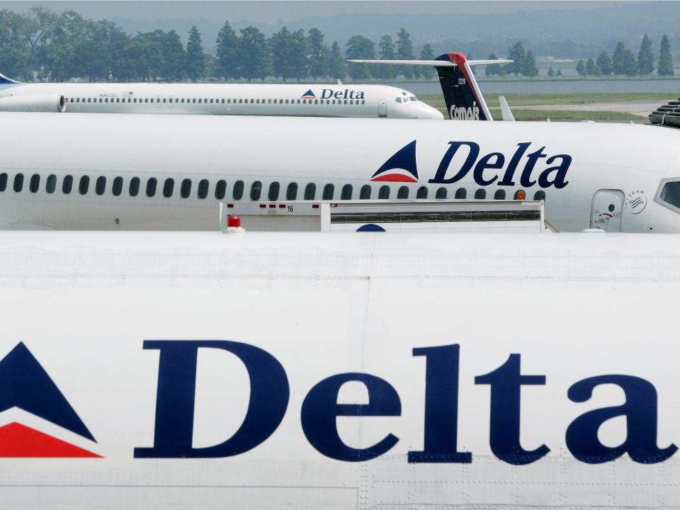 Delta Airlines jets sit at terminal at Reagan National Airport outside Washington in this August 19, 2004 file photo. REUTERS/Larry Downing/File Photo