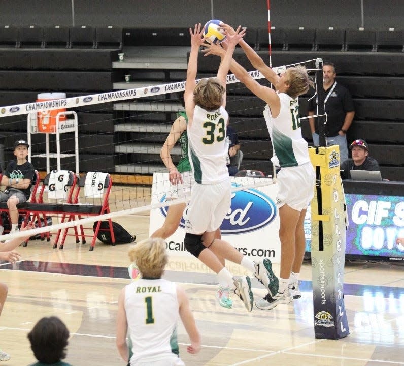 Royal's Kenneth Woods (33) and Derek Bradford go for the block during the Highlanders' sweep of Upland in the CIF-SS Division 3 championship match on Saturday at Long Beach City College.