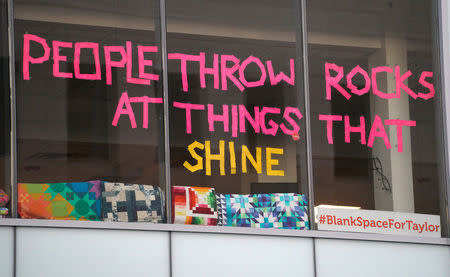 A sign in an office building is seen across the street from Denver Federal Court where the Taylor Swift groping trial goes on in Denver, U.S., August 14, 2017. REUTERS/Rick Wilking