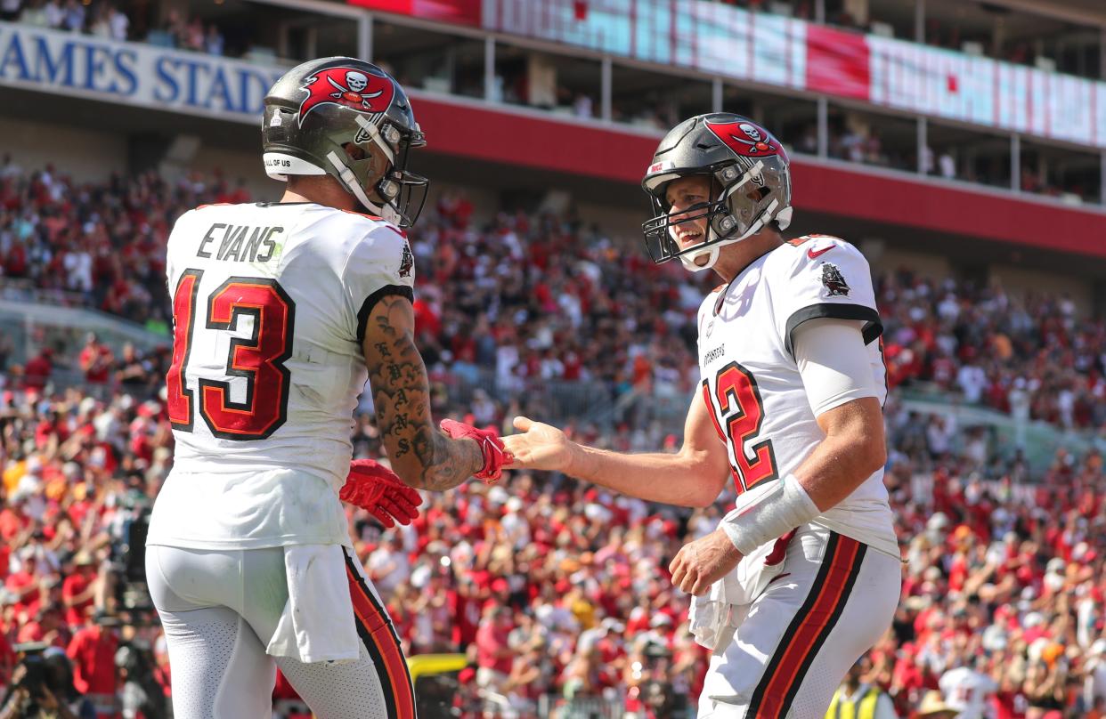 TAMPA, FL - OCTOBER 10: Tom Brady (12) of the Buccaneers congratulates Mike Evans (13) on scoring a touchdown during the regular season game between the Miami Dolphins and the Tampa Bay Buccaneers on October 10, 2021 at Raymond James Stadium in Tampa, Florida. (Photo by Cliff Welch/Icon Sportswire via Getty Images)